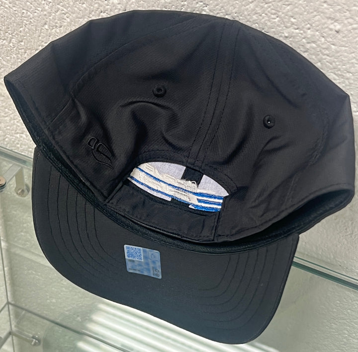 Black cap with Adidas logo on a textured white background