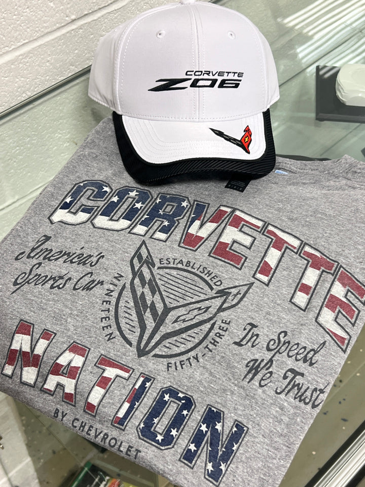 Gray 'Corvette Nation' t-shirt with a white and black cap featuring 'Corvette Z06' on a reflective surface.