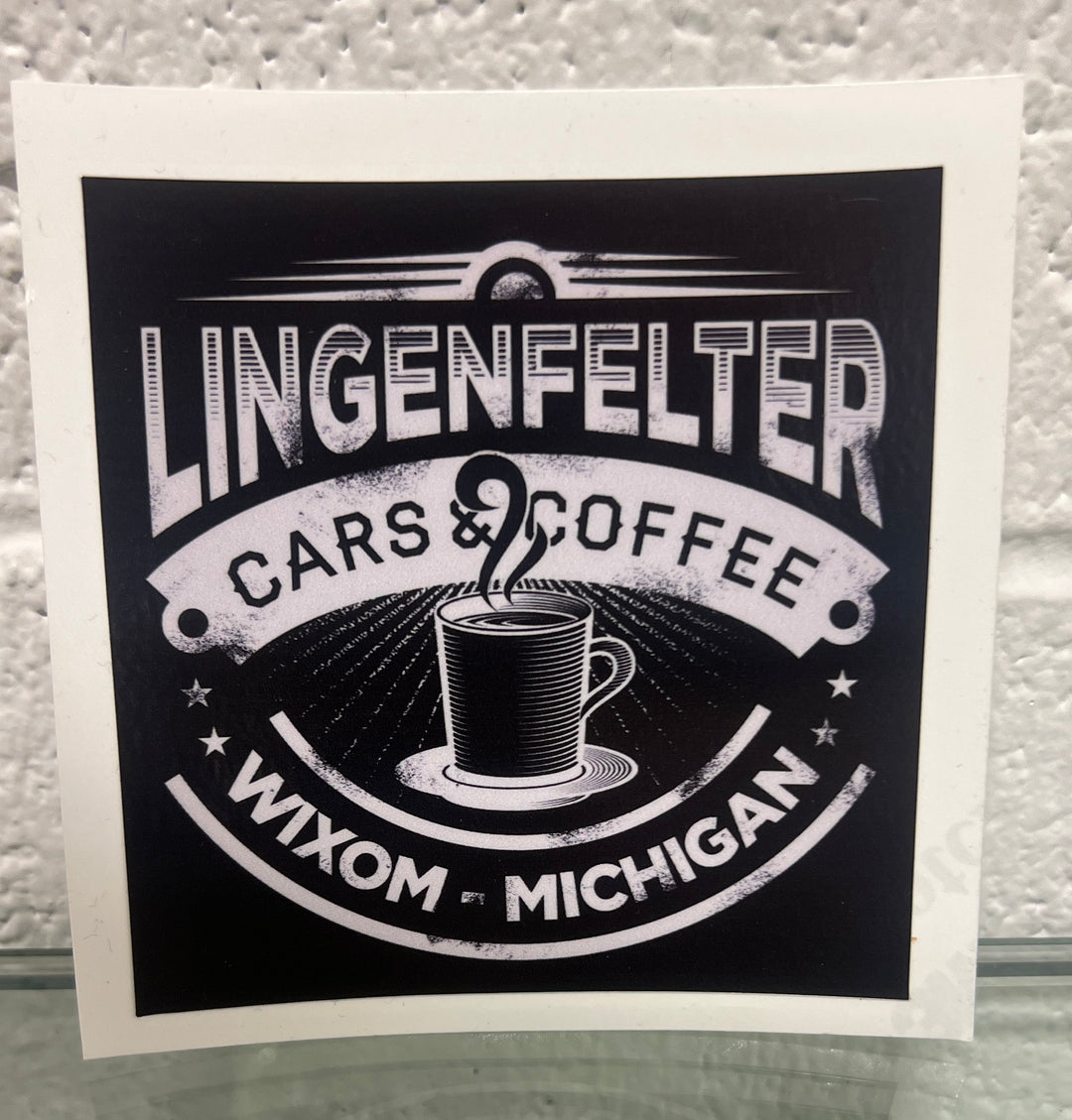 Sticker with 'Lingenfelter Cars & Coffee Wixom Michigan' text and coffee cup graphic on a textured background.