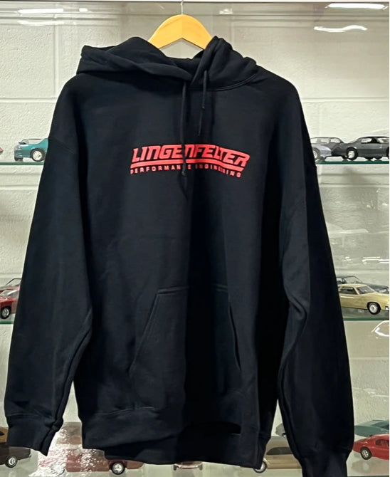 Black hoodie with red logo on a hanger against a car showroom background