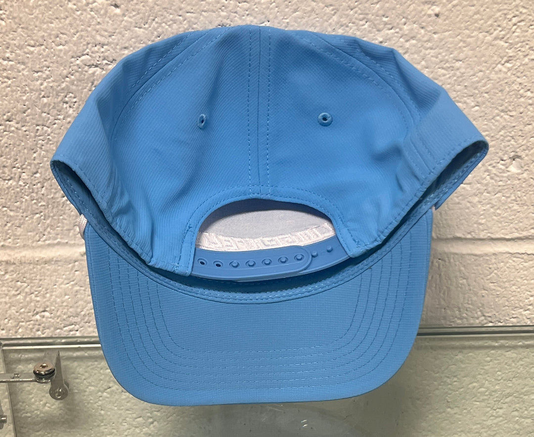 Blue baseball cap on a textured wall