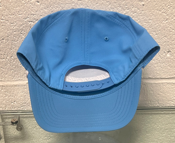 Blue baseball cap on a textured wall