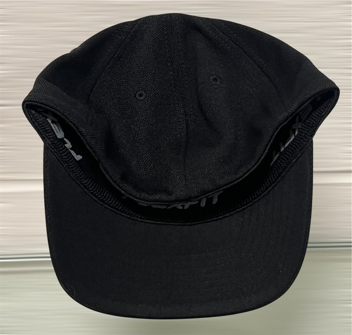 Black cap on a light wooden surface