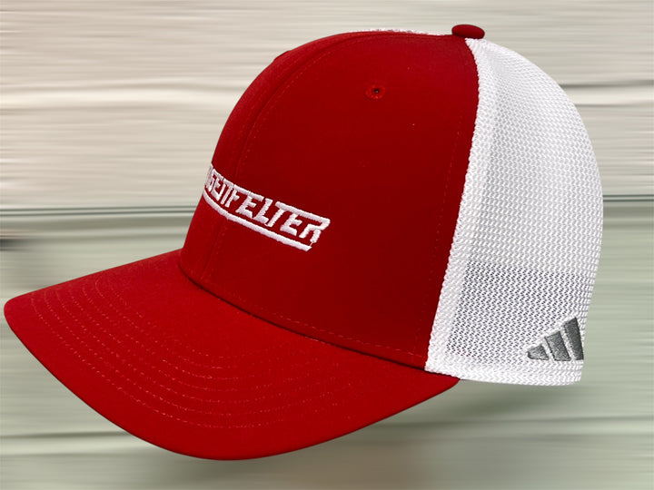 Red and white cap with a visible brand logo on a neutral background