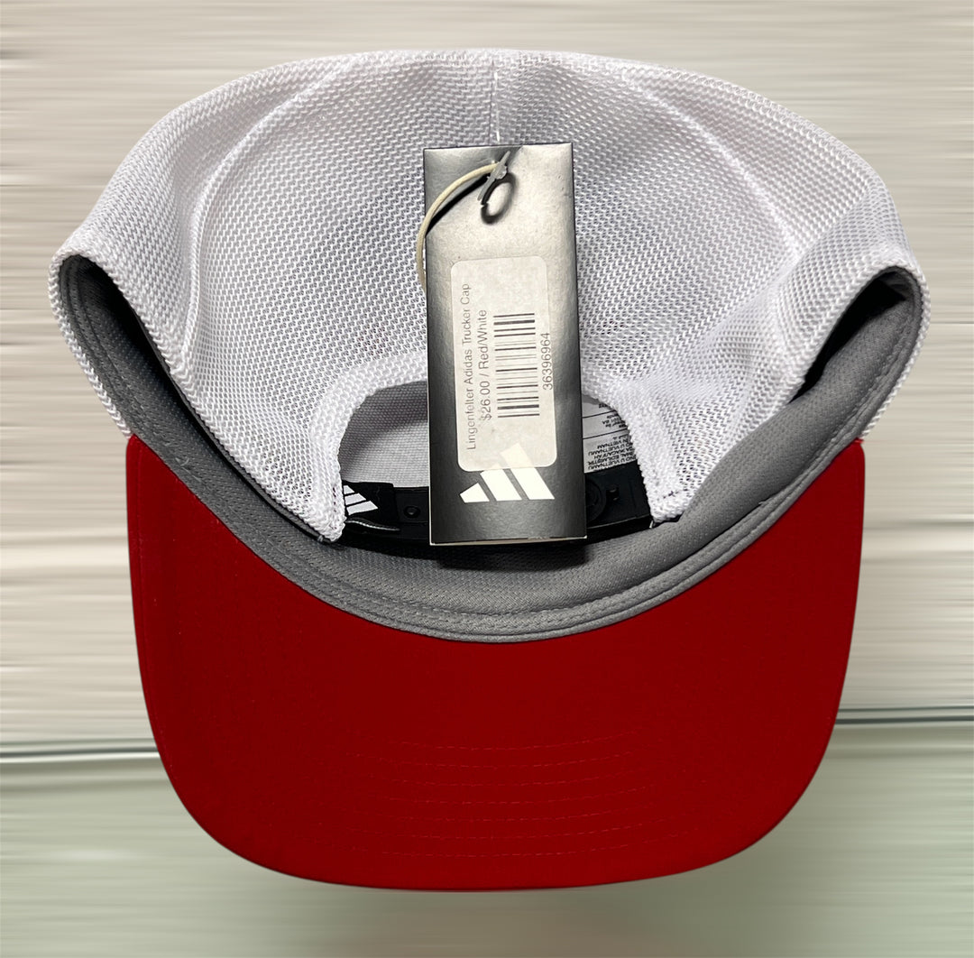 Red and gray cap with an Adidas tag on a neutral background