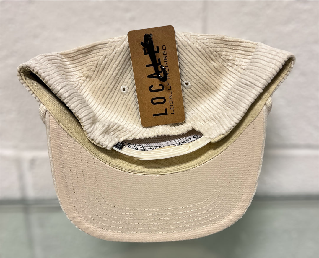 Beige cap with a brown tag on a light gray background