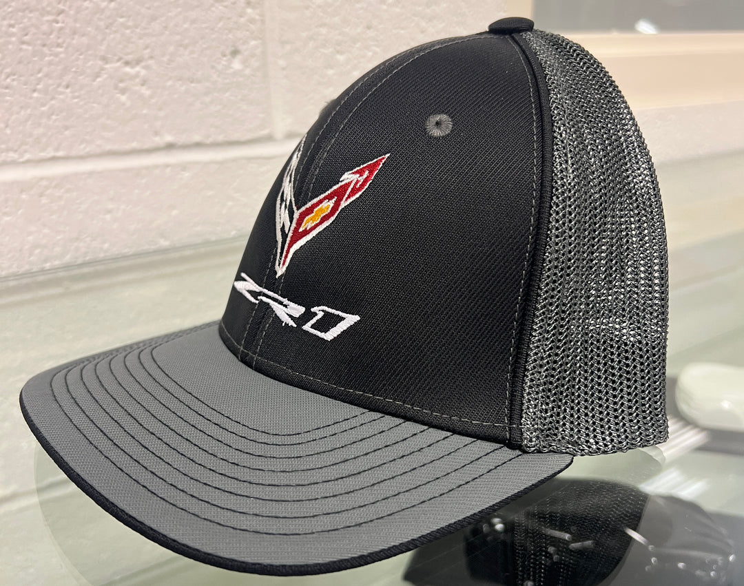 Black and graphite ZR1 Corvette Flexfit trucker hat by Team Lingenfelter, featuring embroidered Corvette logo and adjustable mesh back.