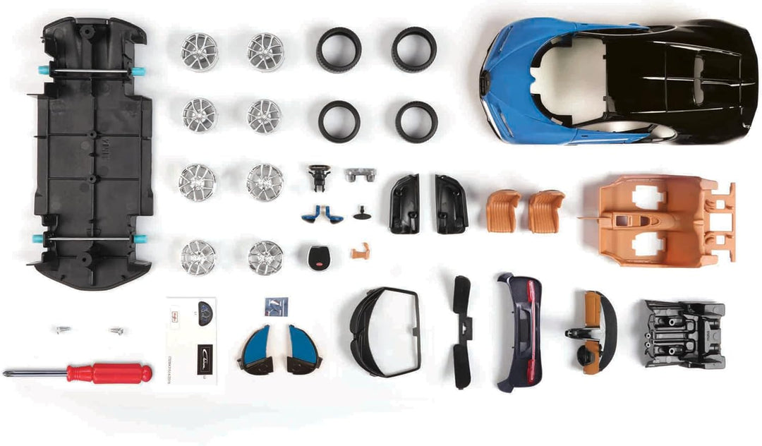 Model car kit with various parts and tools on a white background