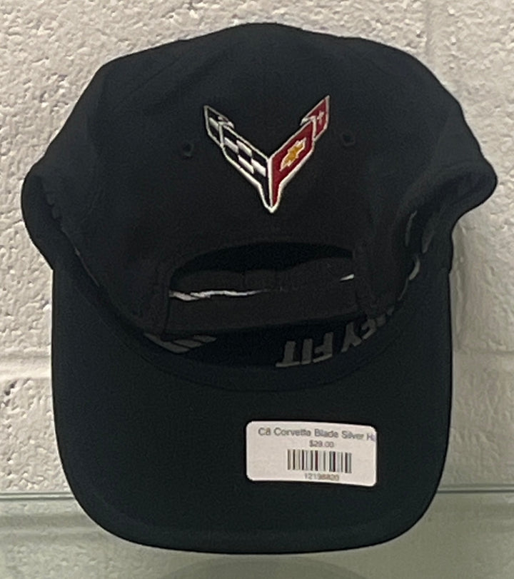 A black baseball cap featuring a silver, red, and white embroidered Corvette logo on the front, with a white retail price tag attached to the brim.