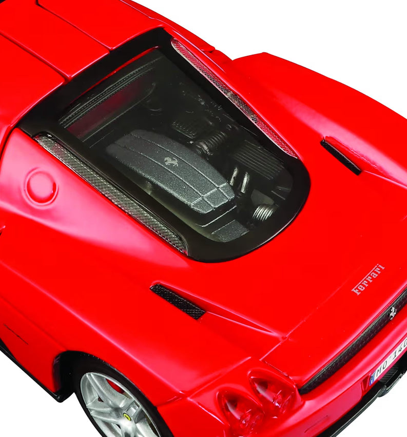 Close-up of a red Ferrari model car with open hood on a white background