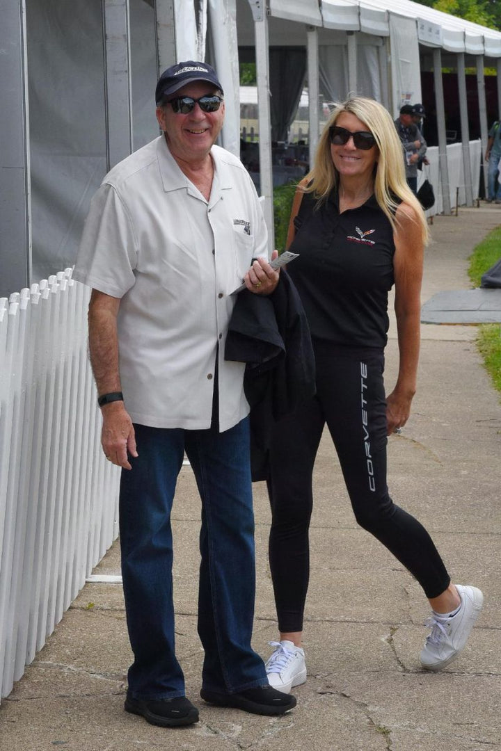 Ken & Kristen Lingenfelter Detroit Grand Prix Kristen wearing black Corvette yoga pants that team lingenfelter sells