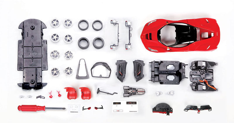 Team Lingenfelter LaFerrari assembly line diecast kit showing detailed plastic and metal parts for model building.