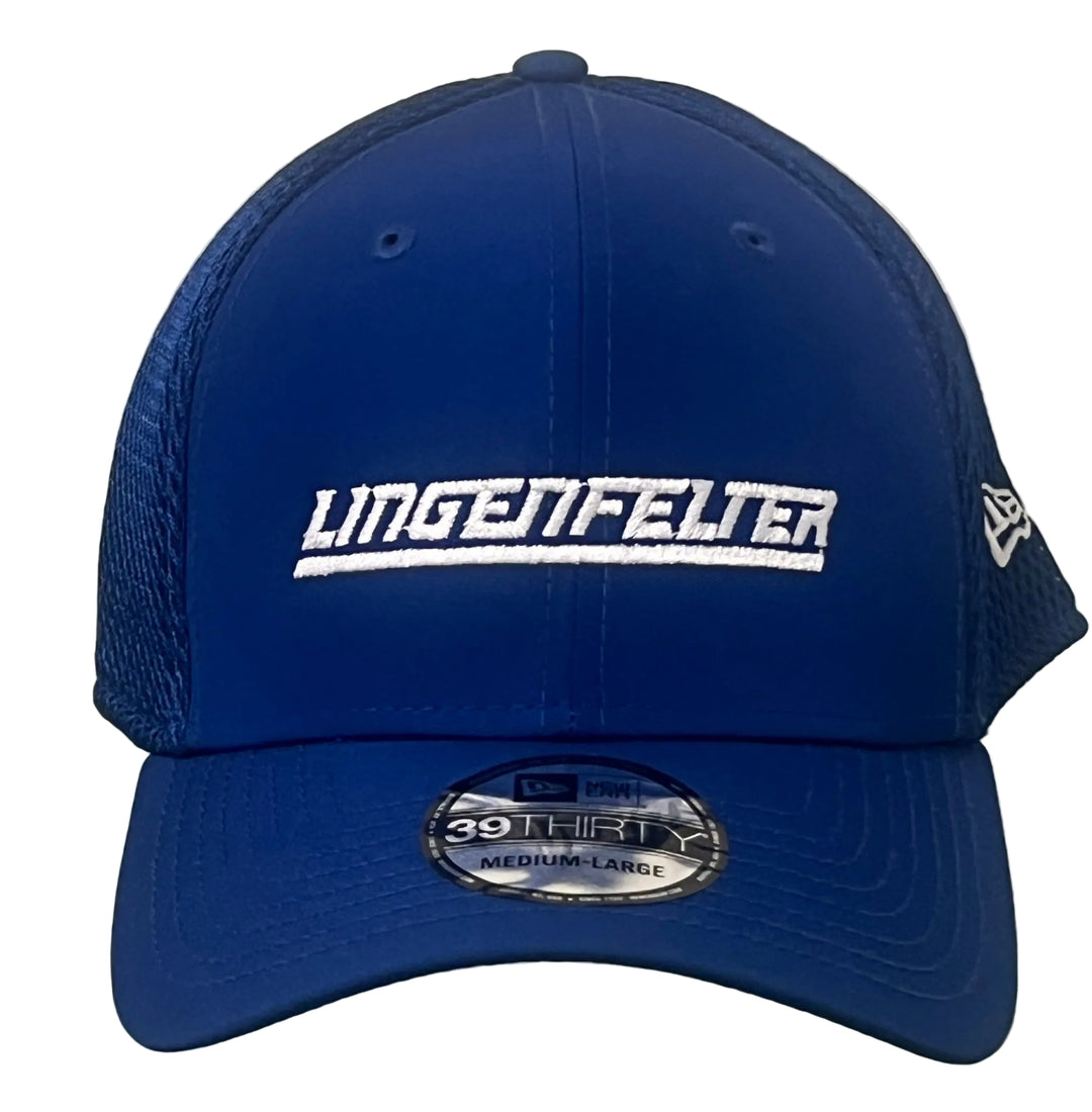 A royal blue trucker-style baseball cap with white embroidered 'LINGENFELTER' text across the front and a New Era 39Thirty sticker on the brim, shown against a white brick wall.