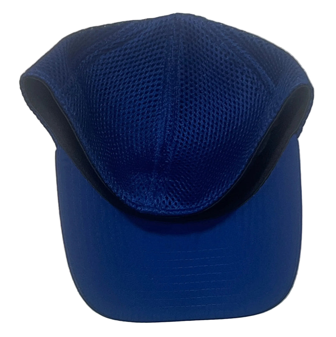 A royal blue baseball cap with a mesh crown and solid curved brim, photographed against a white textured wall.
