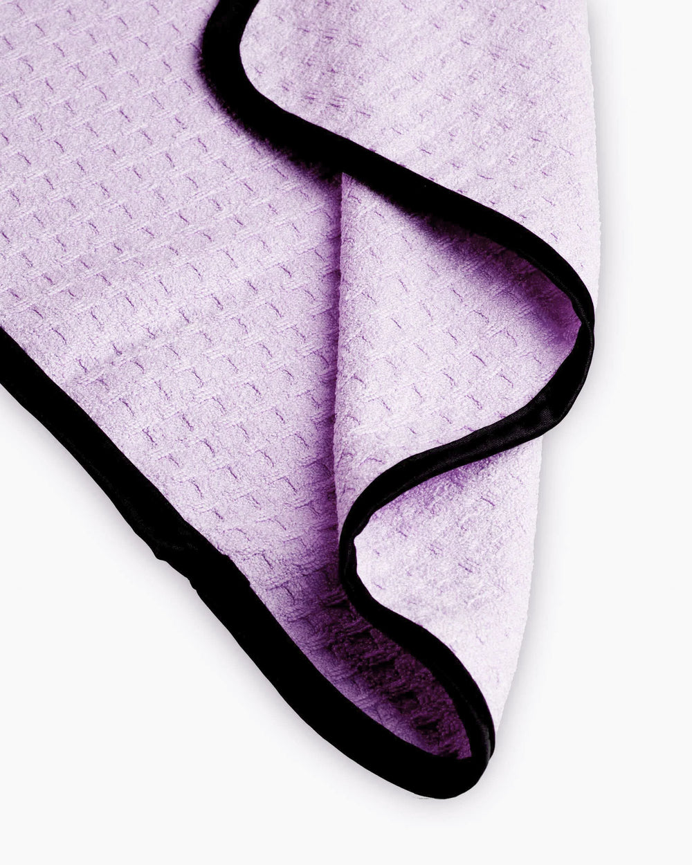 Purple textured towel with black border on a white background