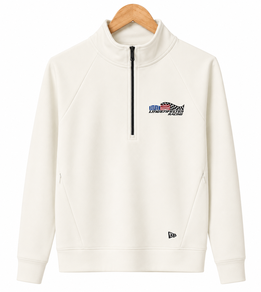 An off-white quarter-zip pullover sweatshirt with a black zipper and a small chest graphic, hanging on a wooden hanger against a white background. A New Era flag logo is visible near the bottom hem.